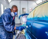 a man painting a car