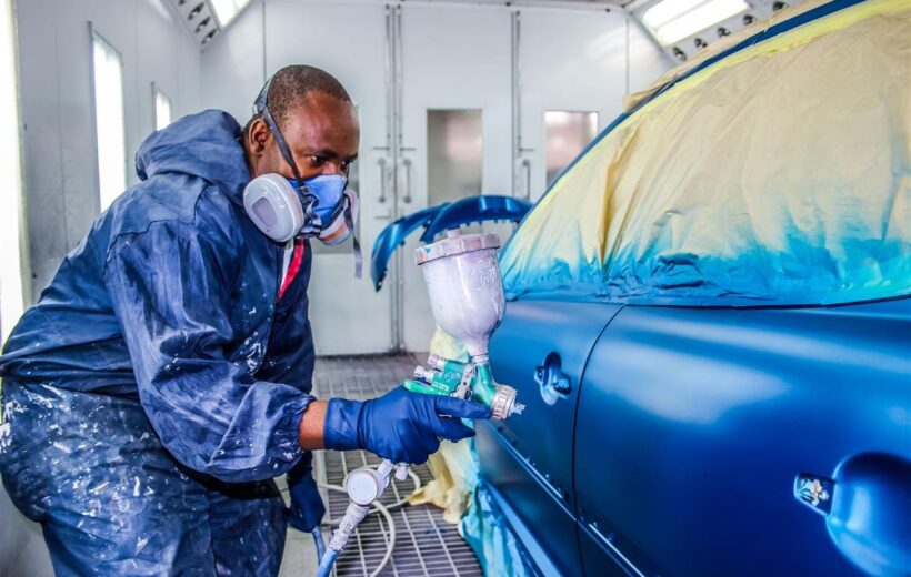 a man painting a car