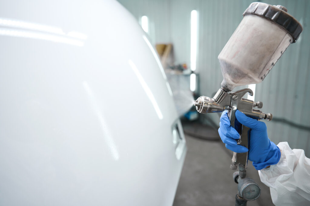 a person painting a car