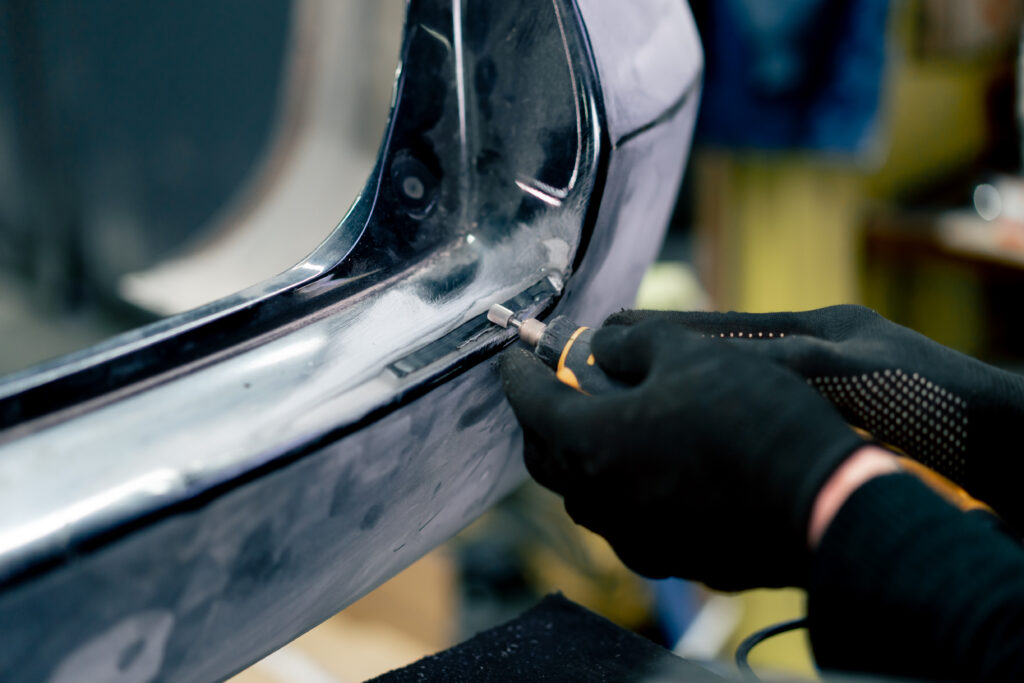 a person using a screwdriver to remove the metal